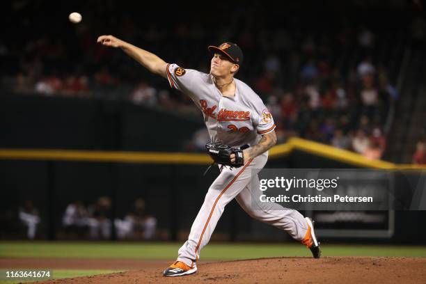 Starting pitcher Aaron Brooks of the Baltimore Orioles pitches against the Arizona Diamondbacks during first inning of the MLB game at Chase Field on...