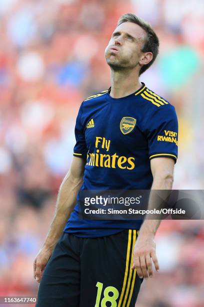Nacho Monreal of Arsenal looks dejected during the Premier League match between Liverpool and Arsenal at Anfield on August 24, 2019 in Liverpool,...