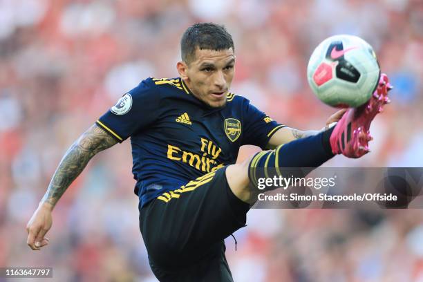 Lucas Torreira of Arsenal leaps to control the ball during the Premier League match between Liverpool and Arsenal at Anfield on August 24, 2019 in...