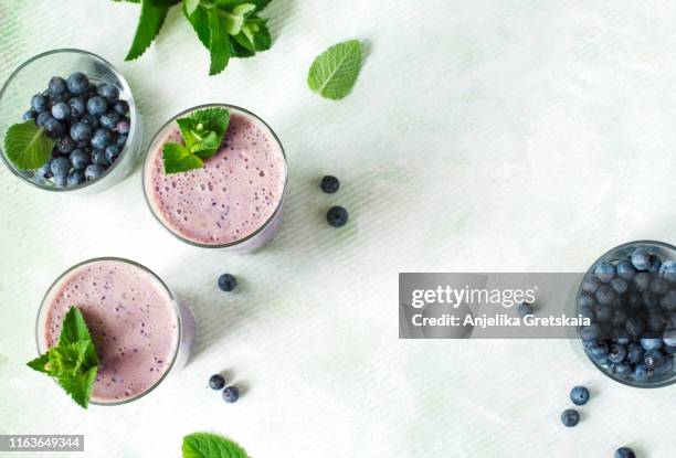 two glasses of blueberry milkshake. top view - breakfast background stock pictures, royalty-free photos & images