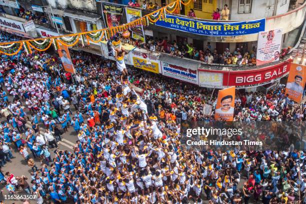 Govindas form a human pyramid to break the 'Dahi Handi', an earthen pot filled with curd hanging above them, as part of celebrations to mark the...