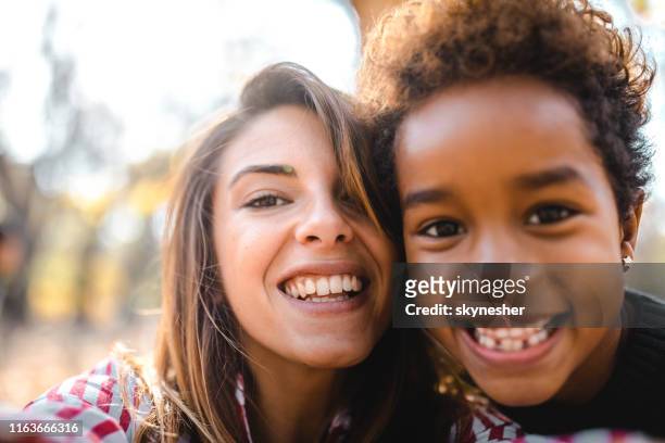 happy nanny and black girl taking a self portrait photography n nature. - nanny stock pictures, royalty-free photos & images