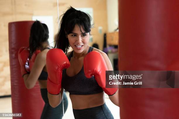 woman boxing with punching bag - punching bag stock pictures, royalty-free photos & images