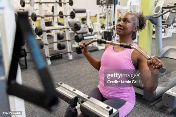 mature woman weight training in gym - strength training stock pictures, royalty-free photos & images