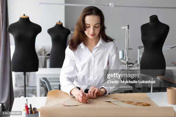 fashion designer working at desk in studio - パタンナー ストックフォトと画像