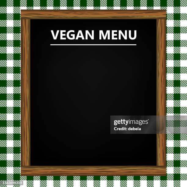 vegan menu blackboard on green gingham pattern background - timber table stock illustrations