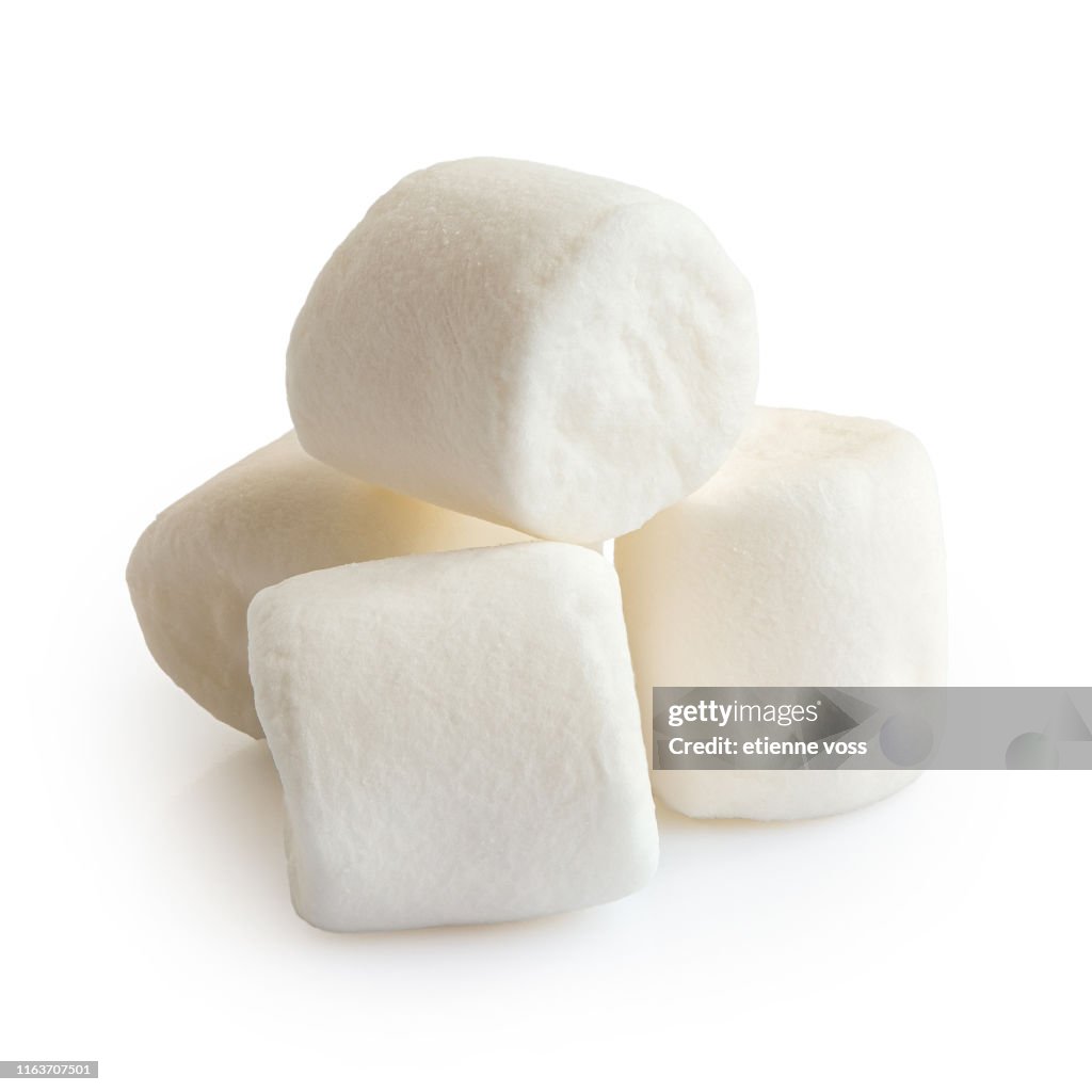 Pile of four white mini marshmallows isolated on white.