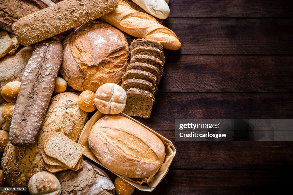 Breads assortment with copy space on rustic wooden table