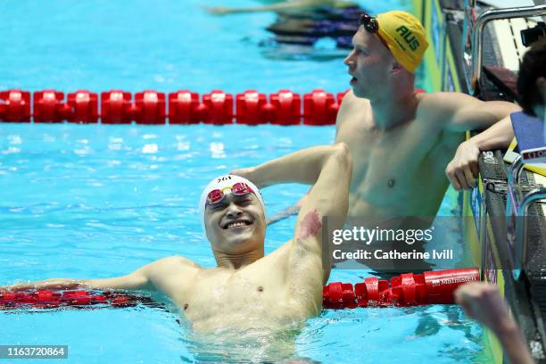 Sun Yang of China celebrates as Clyde Lewis of Australia looks on after the Men's 200m Freestyle Final on day three of the Gwangju 2019 FINA World...