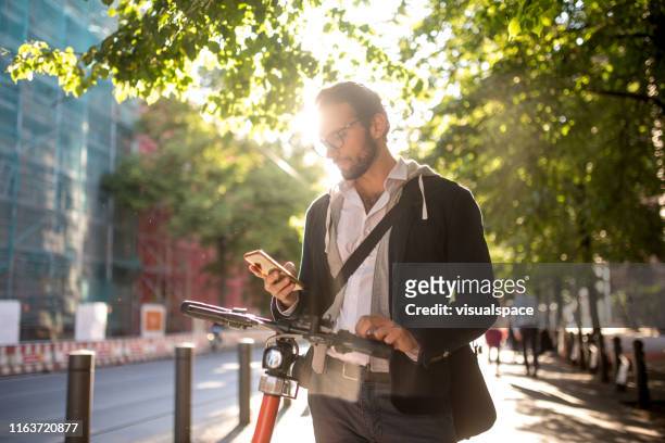 aktivera elektrisk skoter från smart phone - man with scooter bildbanksfoton och bilder