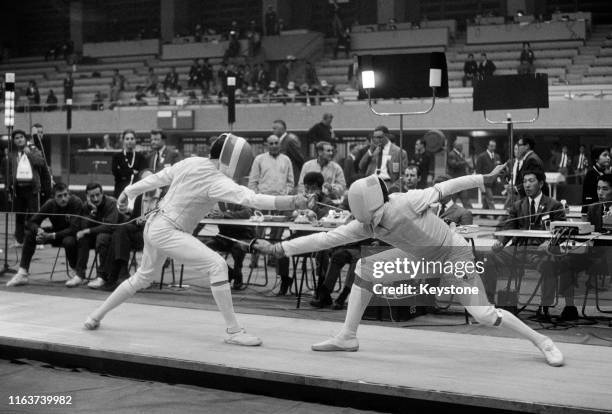 Egon Franke of Poland competes against Henry Hoskyns of Great Britain in the Men's Individual Foil Fencing competition on 13th October 1964 during...