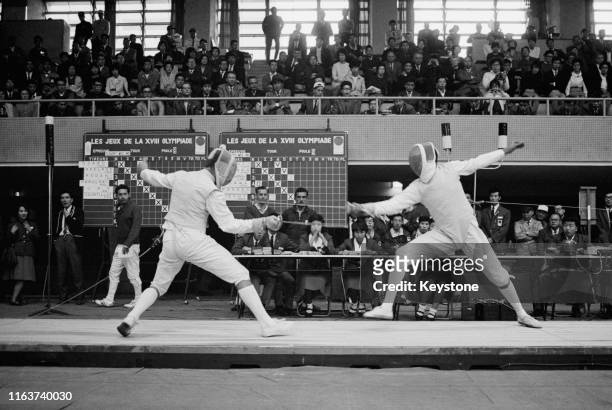 Julius Brecht of the United Team of Germany competes against Sameh Abdelrahman of the United Arab Republic in the Men's Individual Foil Fencing...