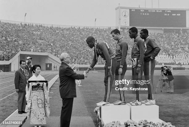 Avery Brundage, President of the International Olympic Committee presents the winning gold medals to Otis Paul Drayton, Gerald Ashworth, Richard...