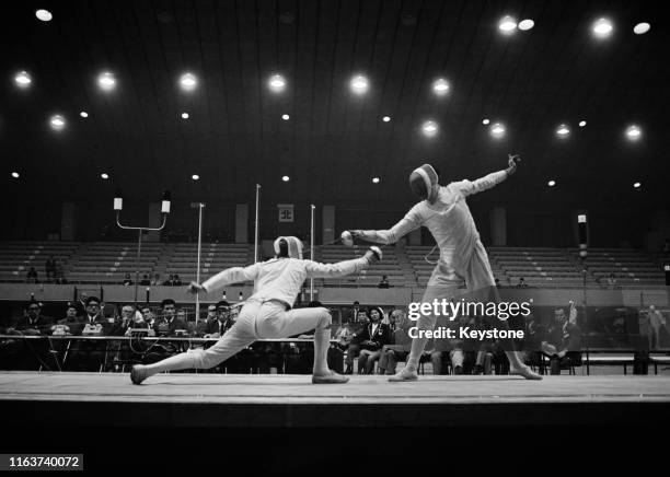István Kausz of Hungary competes against Gianfranco Paolucci of Italy in the Men's Team Epee Fencing competition on 21st October 1964 during the...