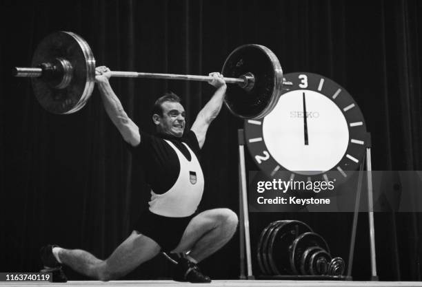 Alfred Kornprobst of the Unified Team of Germany competes in the Men's Lightweight 67.5 kg Weightlifting competition on 13th October 1964 during the...