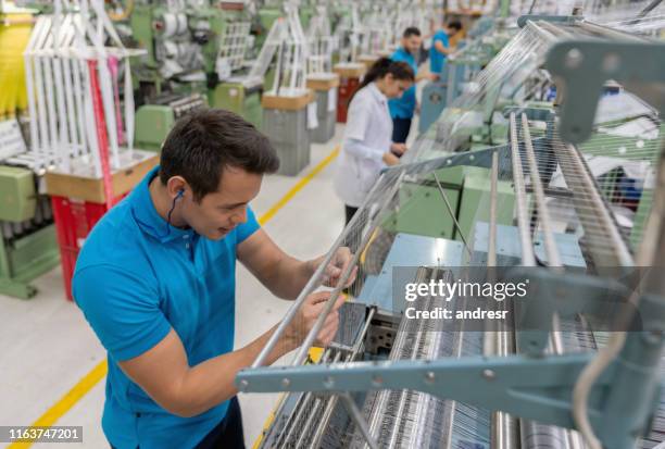 operator working at a textile factory - ear plug stock pictures, royalty-free photos & images