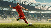 Soccer player kicks a ball