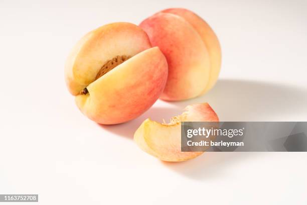 close-up of fruit against white background - 桃 ストックフォトと画像