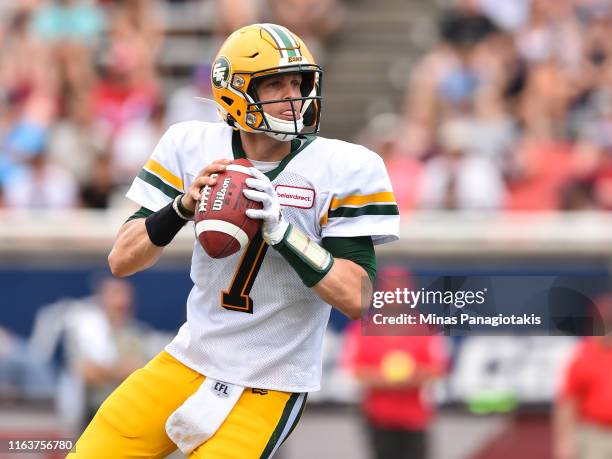 Trevor Harris of the Edmonton Eskimos looks to pass the ball against the Montreal Alouettes during the CFL game at Percival Molson Stadium on July...