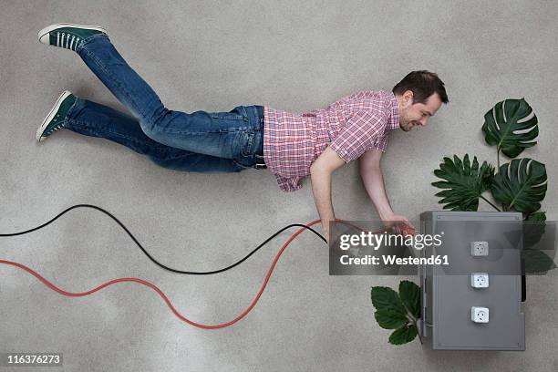 Man Plugged In Ev Plug In Photos and Premium High Res Pictures - Getty Images