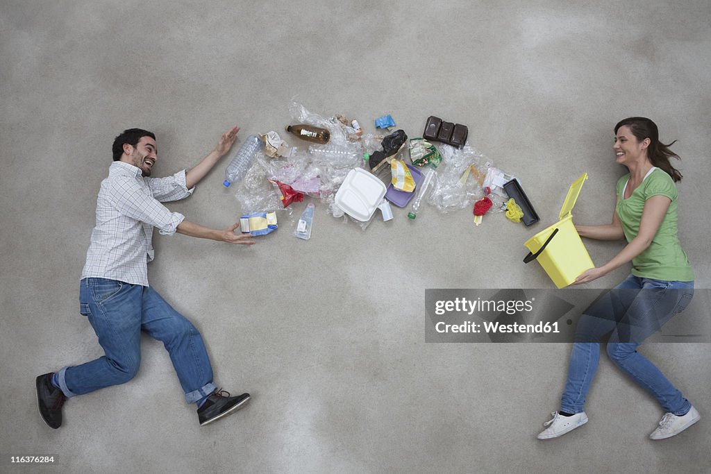 Woman throwing garbage towards man