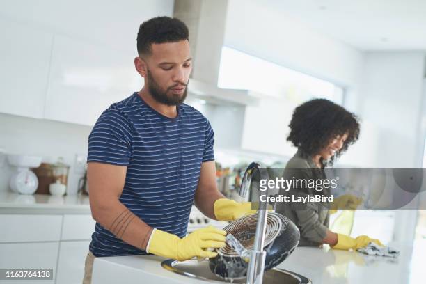 teamwork makes the chores go quicker - black glove stock pictures, royalty-free photos & images