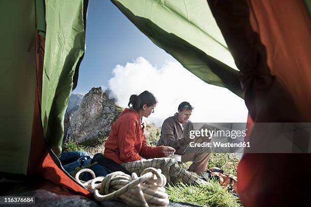 austria, salzburg country, filzmoos, couple sitting on mountains looking map - climbing plant stock-fotos und bilder