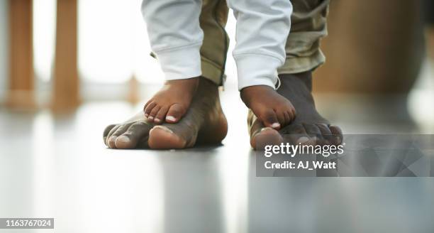 raise them to stand on their own two feet - black men feet stock pictures, royalty-free photos & images