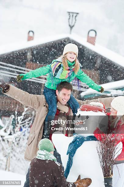 austria, salzburg, hüttau, family preparing snowman - girl scarf bildbanksfoton och bilder