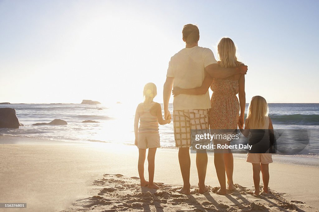 Family on beach holding hands