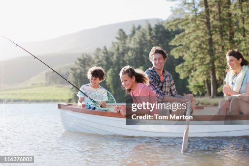 Family fishing in boat on lake Family fishing in boat on lake