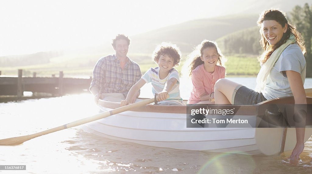 Family in rowboat on lake