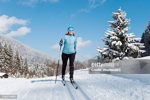 germany, bavaria, aschermoos, senior woman doing cross-country skiing - senior winter sport stock pictures, royalty-free photos & images