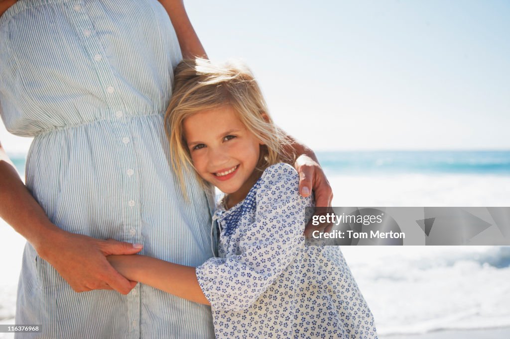 Girl hugging mother on beach