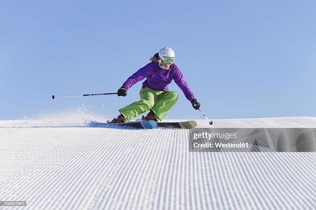 Italy, Trentino-Alto Adige, Alto Adige, Bolzano, Seiser Alm, Young woman skiing