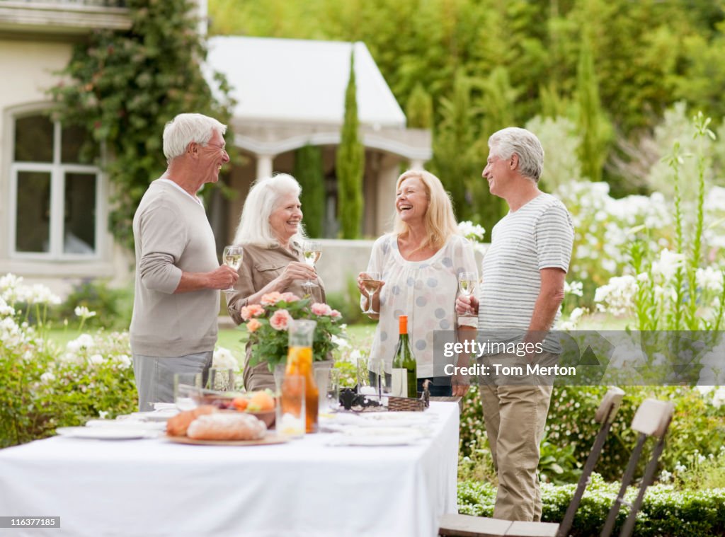 Couples drinking wine in garden