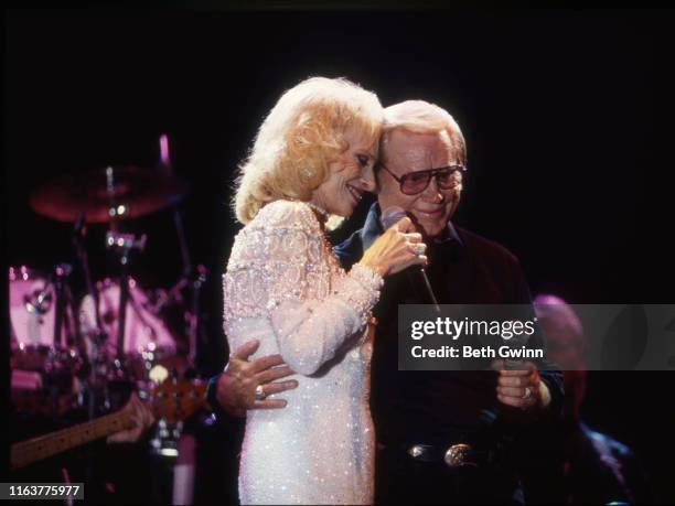 Country Music Singer Songwriter Tammy Wynette and George Jones performs at Fanfair on January 1, 1995 in Nashville, Tennessee