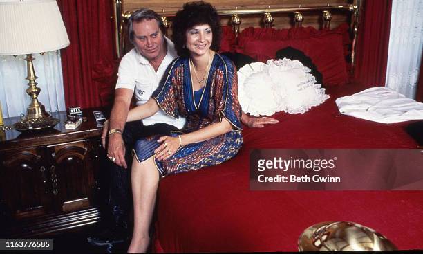 Colmesneil,TX -January 1: Country Music Singer Songwriter George Jones and Nancy Jones sit on bed in their home on January 1, 1985 in Colmesneil,TX