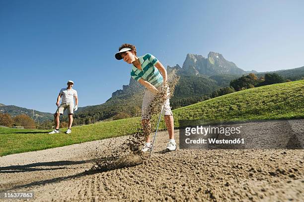 italy, kastelruth, golfers on golf course - golf short iron stock pictures, royalty-free photos & images