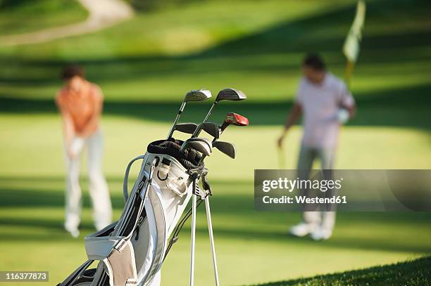 italy, kastelruth, golfers playing golf on golf course - golf bag stock pictures, royalty-free photos & images