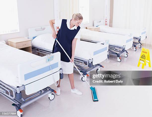 orderly mopping hospital floor - sweeping floor stock pictures, royalty-free photos & images