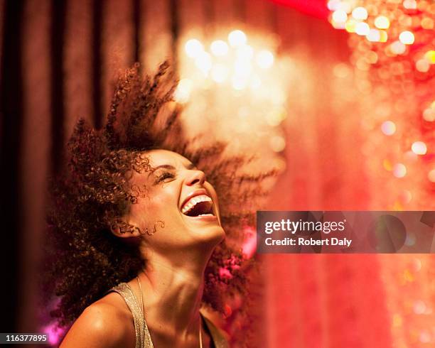 woman dancing at nightclub - nightclub stockfoto's en -beelden