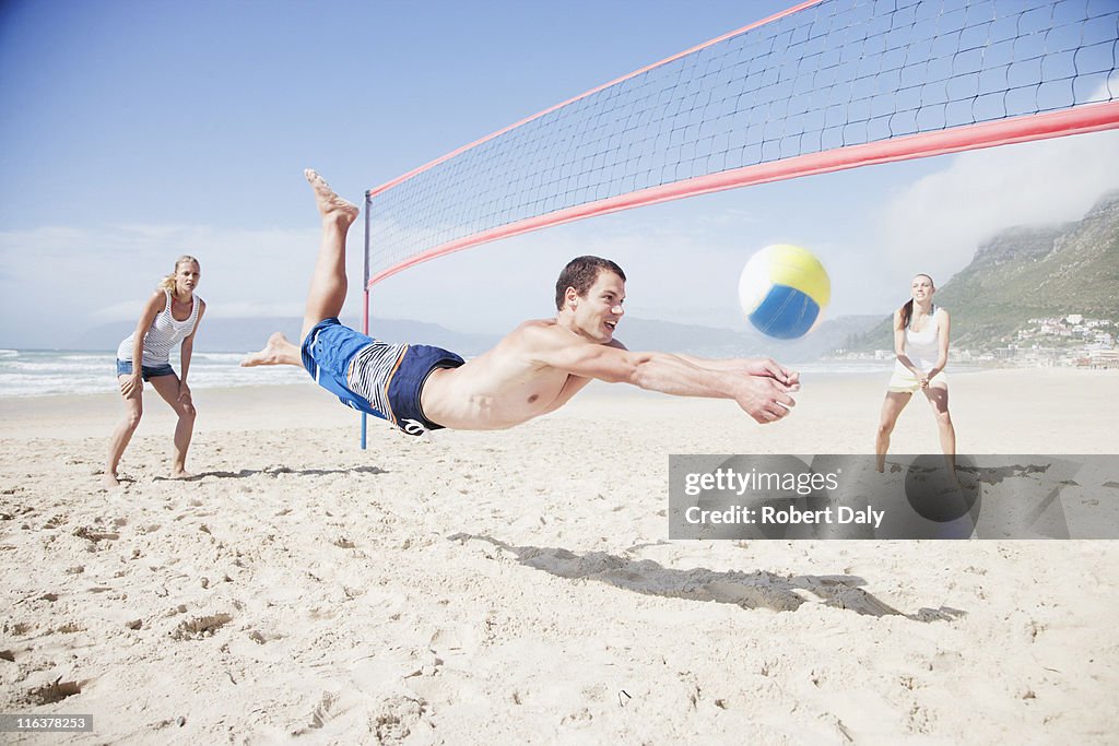 Friends playing volleyball on beach