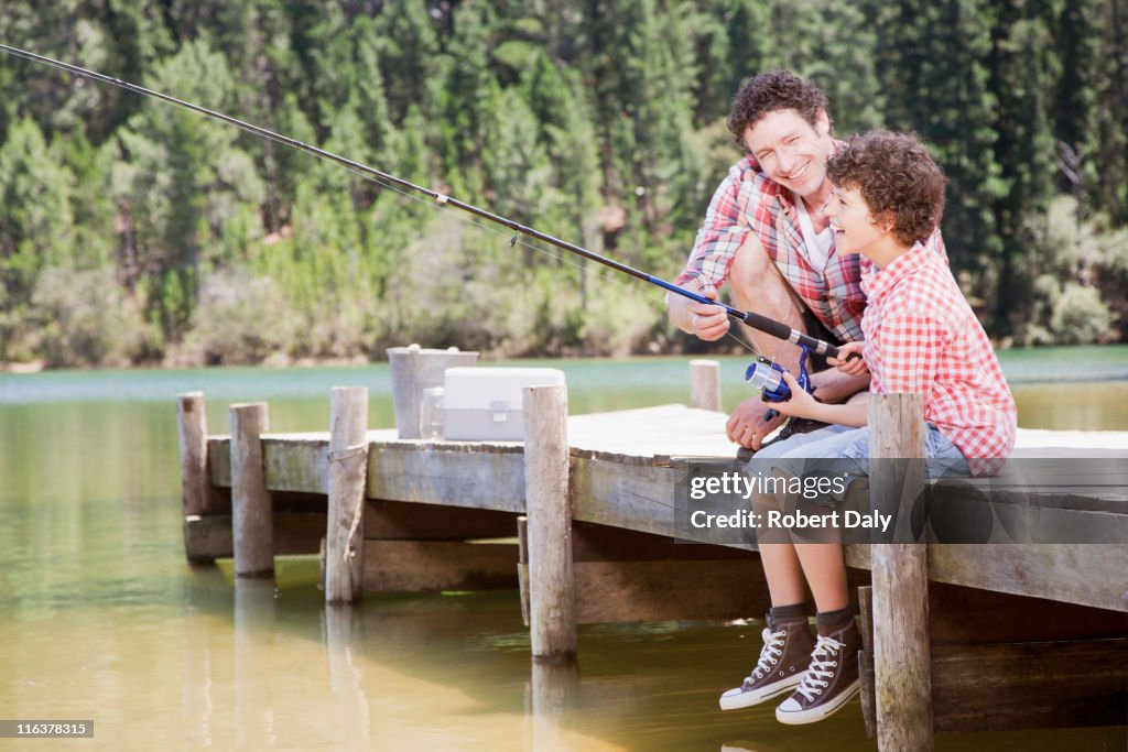 Father and son fishing off dock
