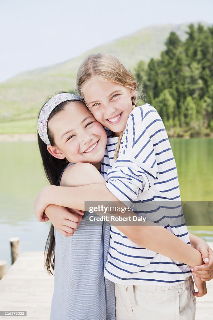 Girls hugging on dock