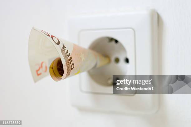 50 euro note kept into electrical socket, close up - konsumerism bildbanksfoton och bilder