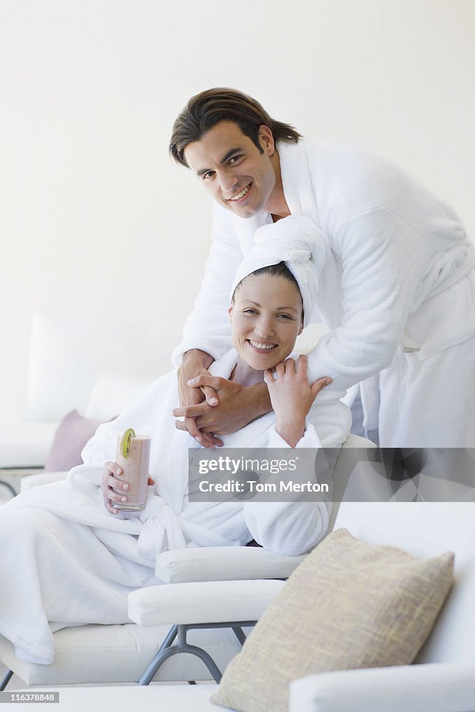 Couple in bathrobes hugging