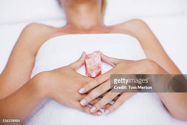 woman laying with crystal - relaxation therapy stock pictures, royalty-free photos & images
