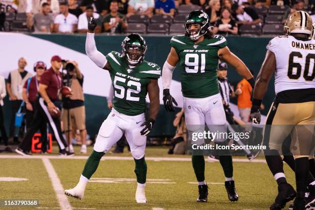 New York Jets Linebacker Anthony Wint reacts to sacking the quarterback along with New York Jets Defensive End Bronson Kaufusi during the second half...