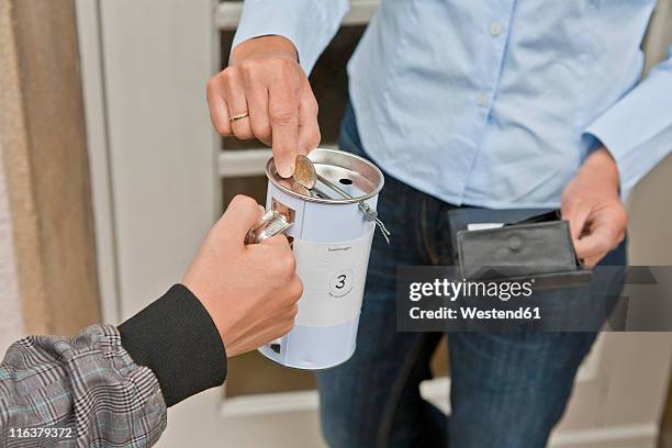 teenage boy donating money at door - money donation stock pictures, royalty-free photos & images